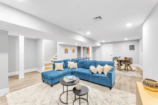 a living room with furniture and a wooden floor