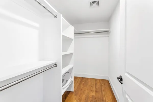 a bathroom with a double sink shower and a toilet