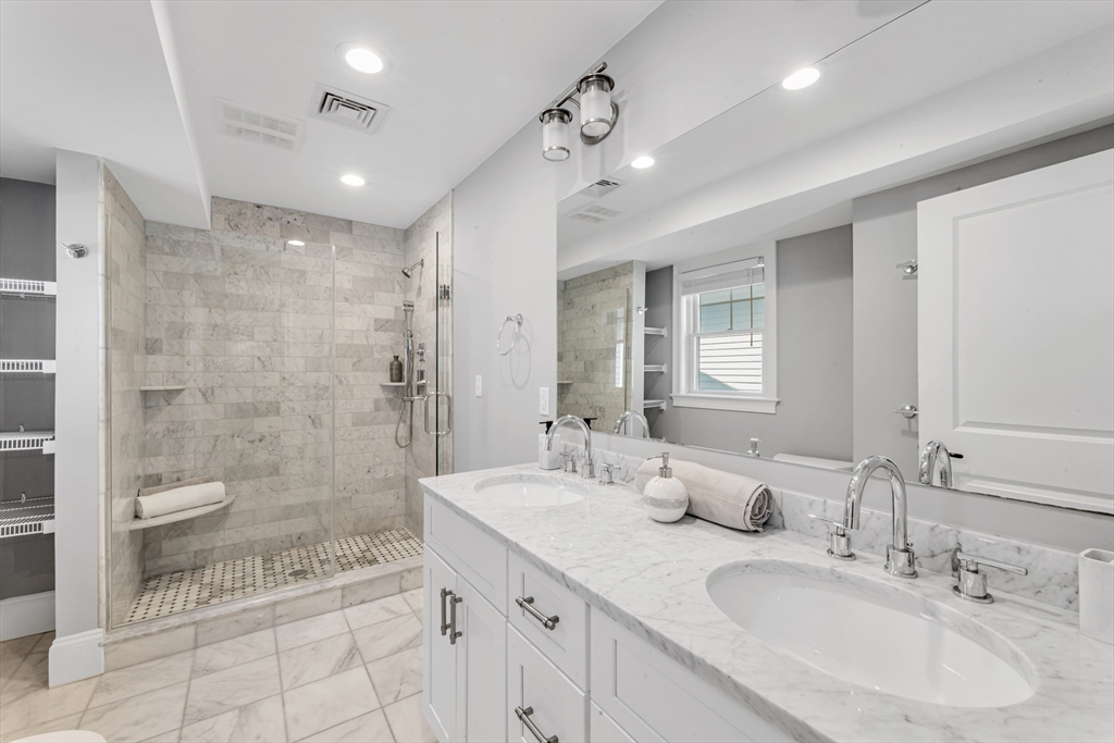 17 June Street, Unit 2 Boston, MA 02131 - Photo 19 of 31 a bathroom with a double sink shower and a toilet