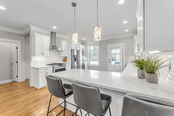 a large kitchen with a table and chairs