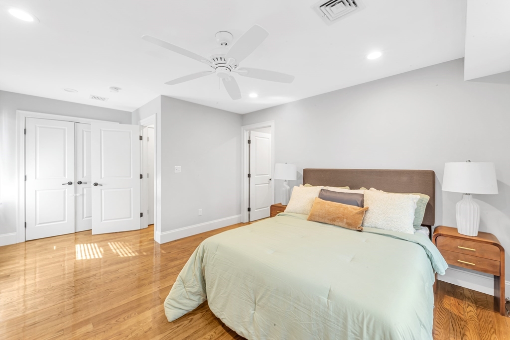 17 June Street, Unit 2 Boston, MA 02131 - Photo 23 of 31 a bedroom with a large bed and wooden floor