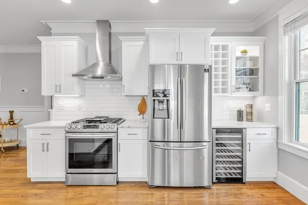 a white refrigerator freezer and a stove sitting inside of a kitchen with granite countertop cabinets
