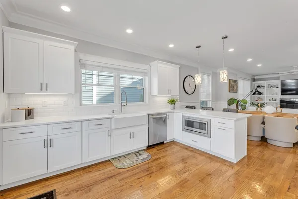 a kitchen with white cabinets and white appliances
