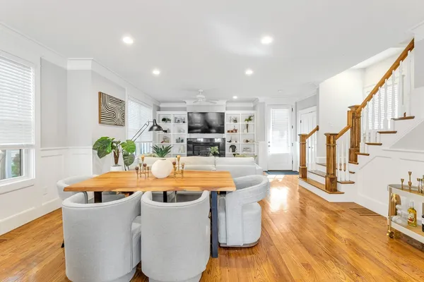 a dining room with furniture and wooden floor