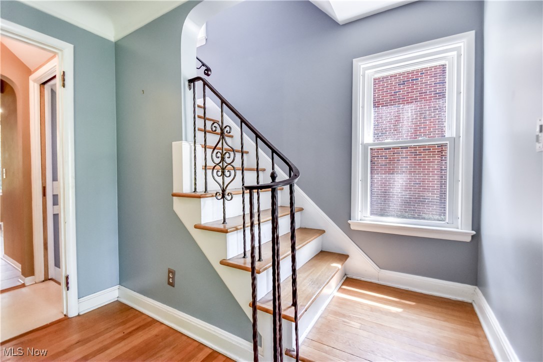 2607 Ashurst Road University Heights, OH 44118 - Photo 12 of 39 Stairway with arched walkways and wood finished floors