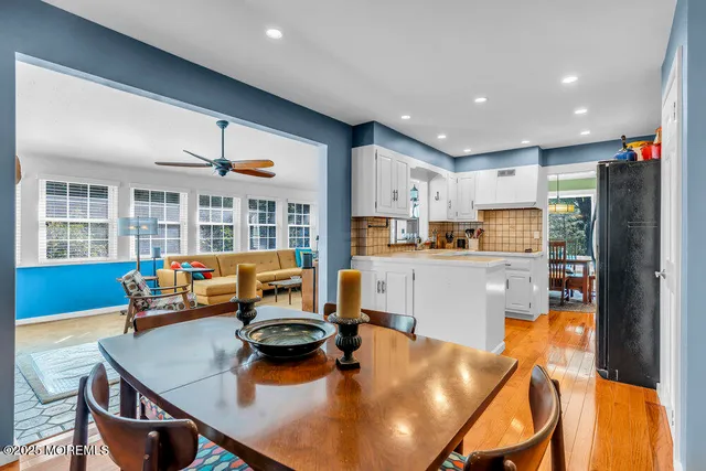 a view of a kitchen with kitchen island granite countertop a refrigerator and a sink