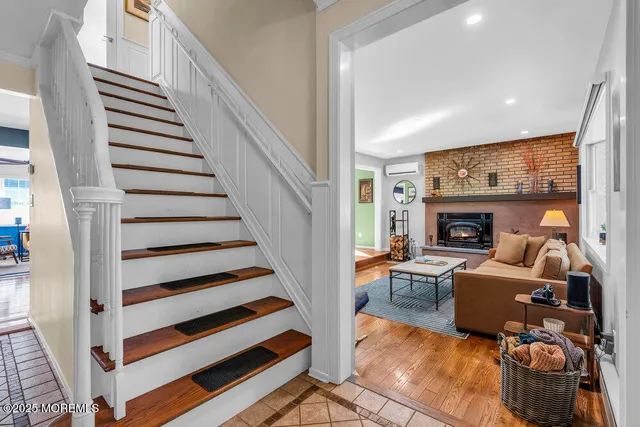 a living room with furniture a fireplace and a large window