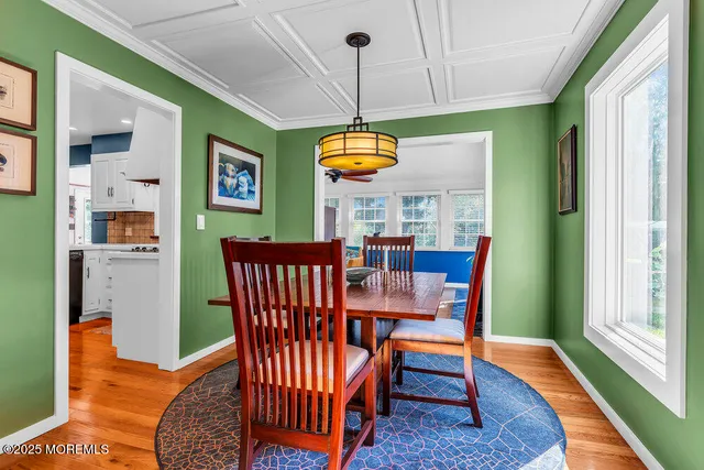 a dining room with furniture a rug and a large window