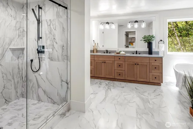 a bathroom with a granite countertop sink mirror and shower