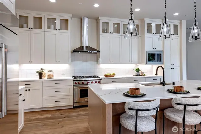 a kitchen with a sink cabinets and wooden floor