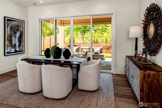 a dining room with furniture and wooden floor