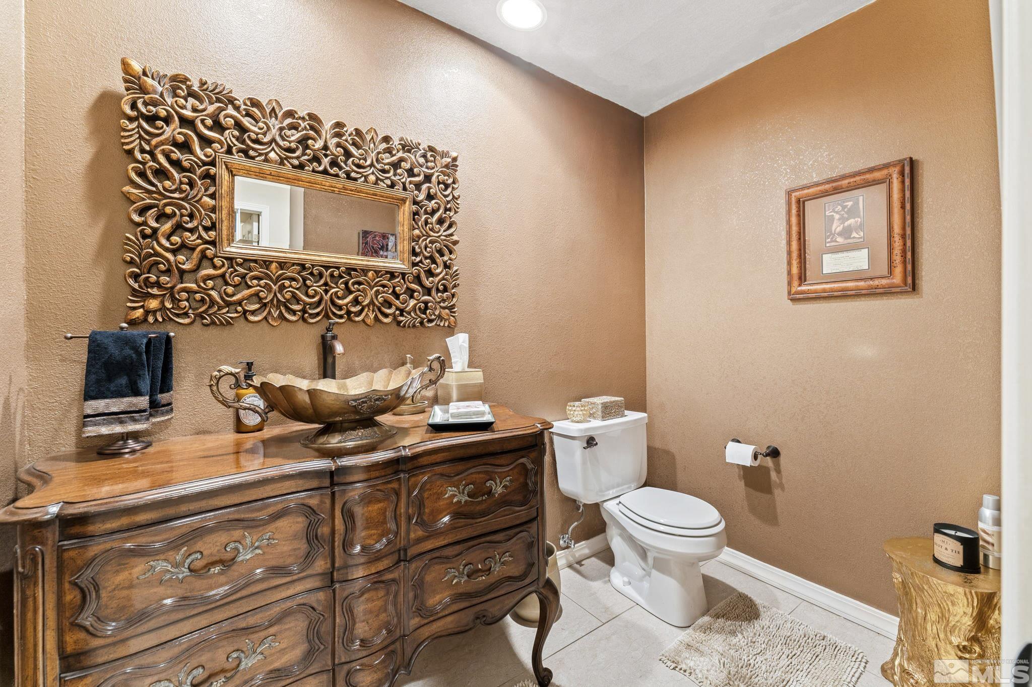 6444 Brookview Circle Reno, NV 89519 - Photo 12 of 32 a bathroom with a toilet a sink and mirror