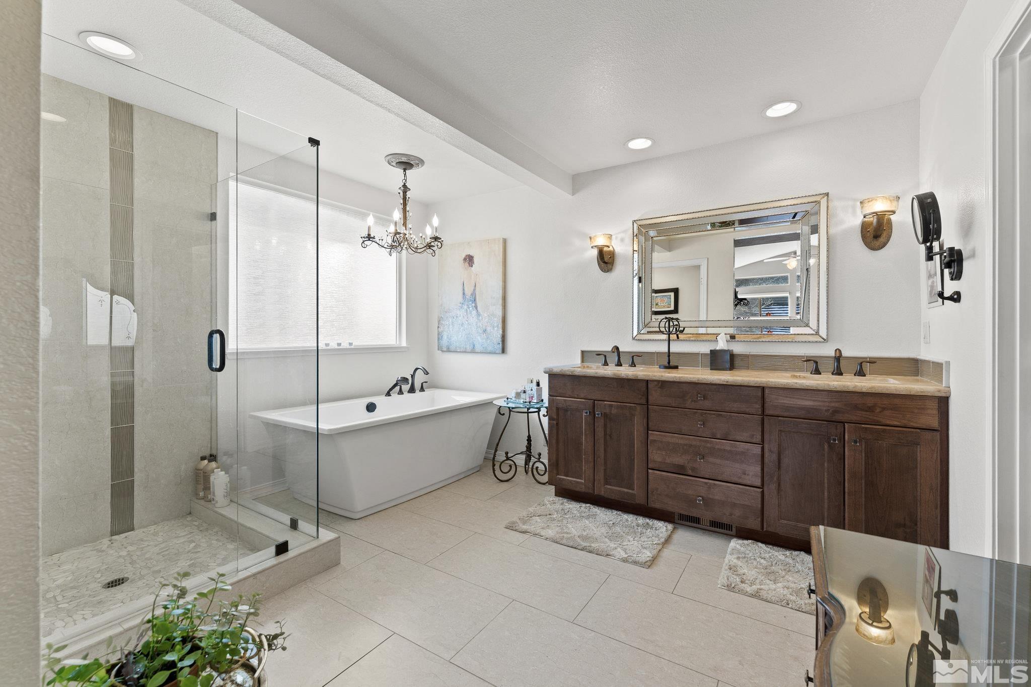6444 Brookview Circle Reno, NV 89519 - Photo 16 of 32 a bathroom with a granite countertop tub sink shower and mirror