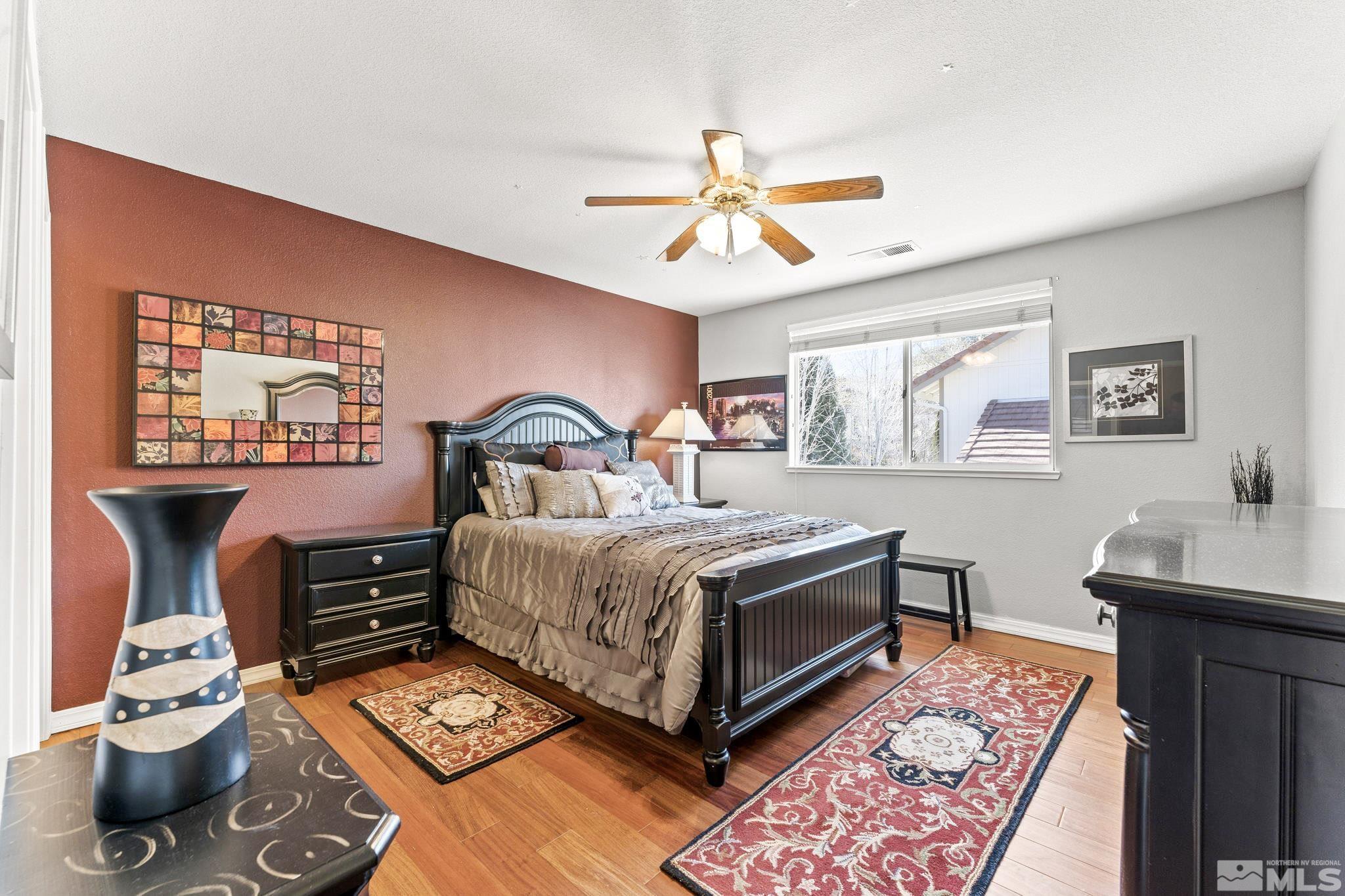 6444 Brookview Circle Reno, NV 89519 - Photo 20 of 32 a bedroom with a bed and wooden floor