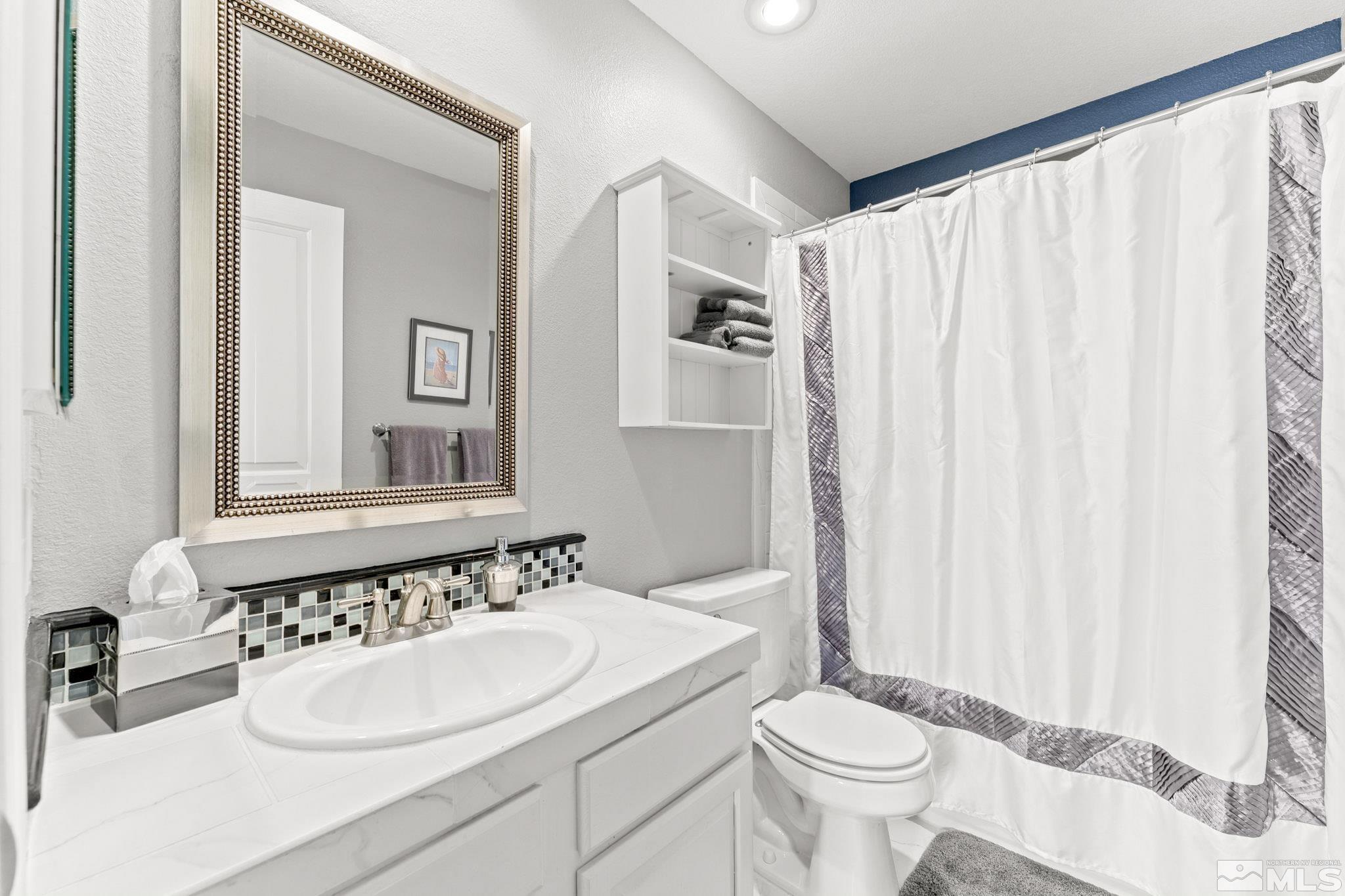 6444 Brookview Circle Reno, NV 89519 - Photo 22 of 32 a bathroom with a sink toilet and a mirror