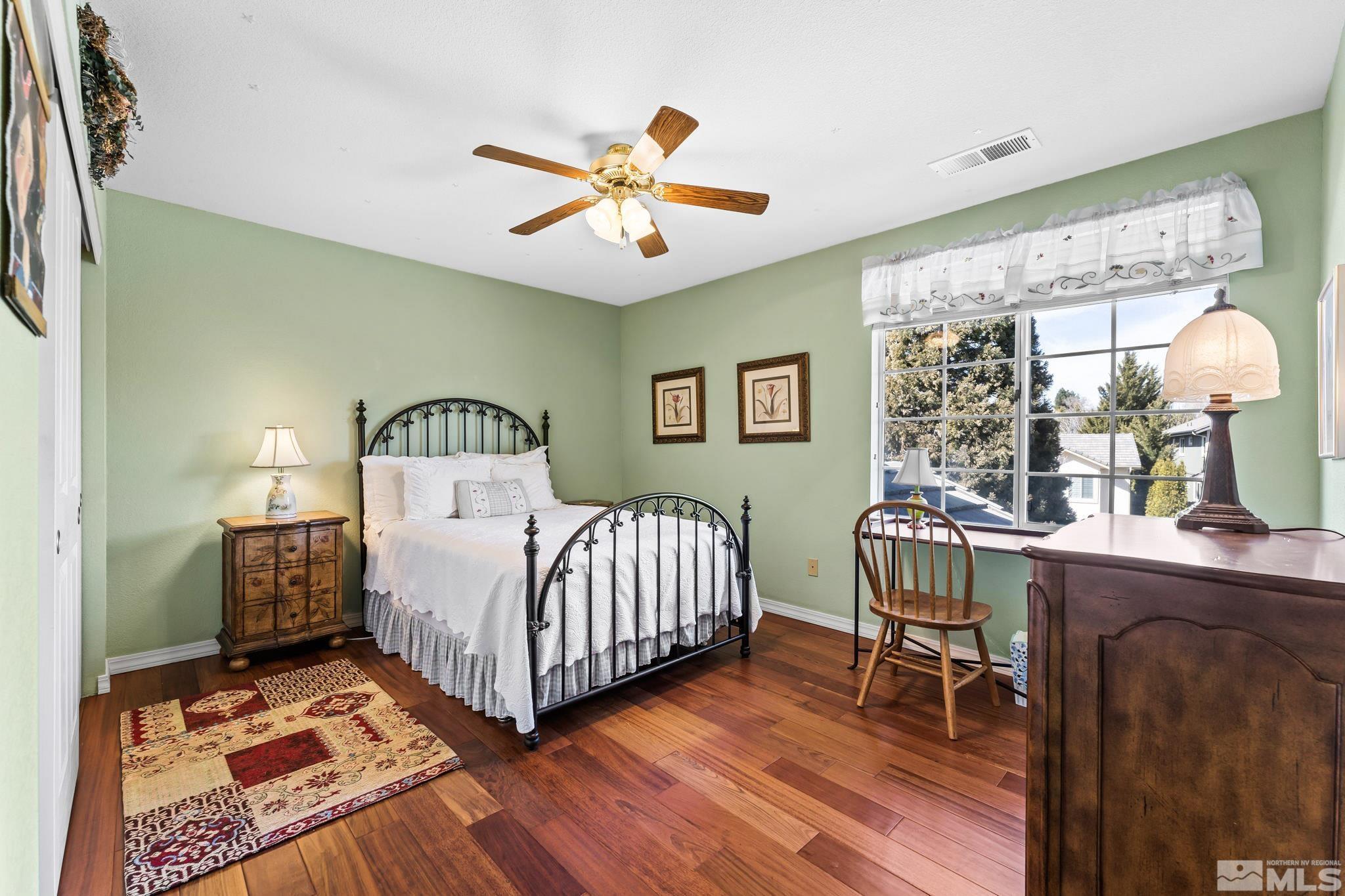 6444 Brookview Circle Reno, NV 89519 - Photo 23 of 32 a bedroom with a bed and a chandelier