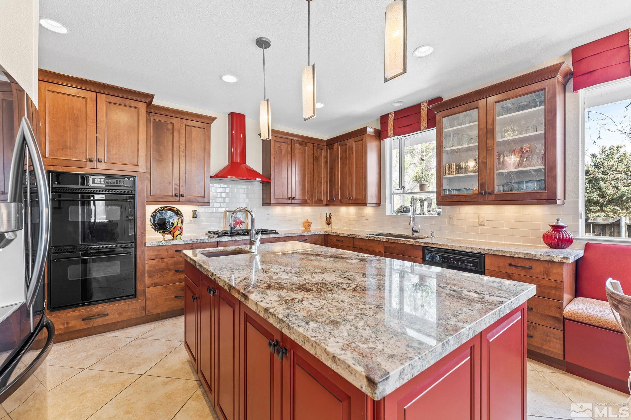 6444 Brookview Circle Reno, NV 89519 - Photo 4 of 32 a kitchen with stainless steel appliances granite countertop a sink dishwasher and cabinets with wooden floor