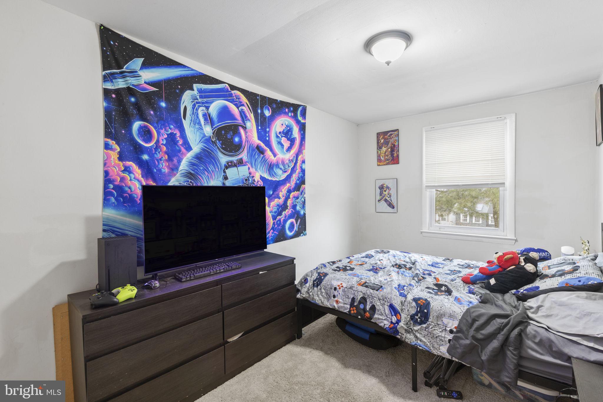 9 Slavin Court, Unit 2H Nottingham, MD 21236 - Photo 11 of 22 a bedroom with a bed and a flat screen tv