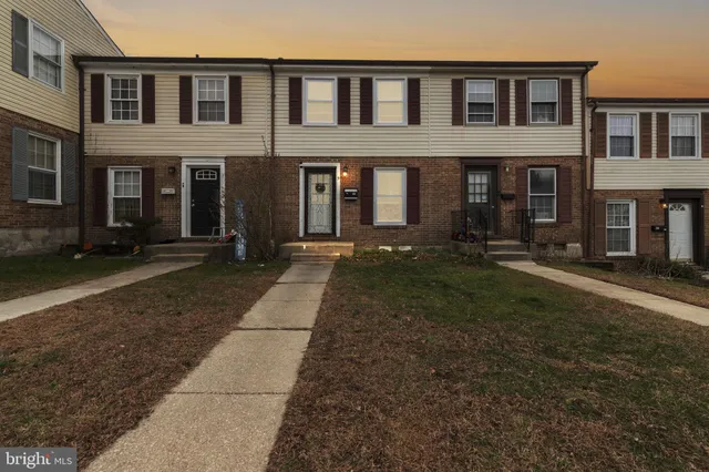 a view of a brick building next to a yard