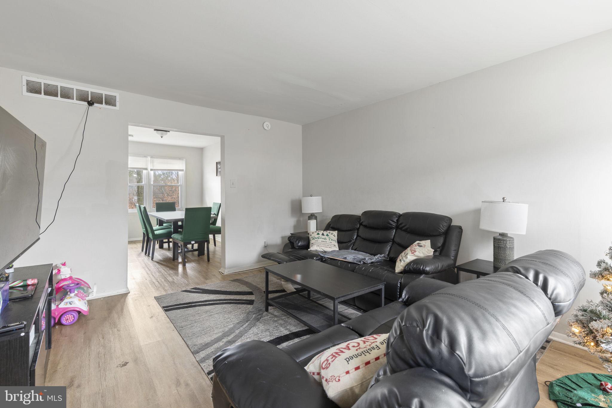 9 Slavin Court, Unit 2H Nottingham, MD 21236 - Photo 2 of 22 a living room with furniture and wooden floor
