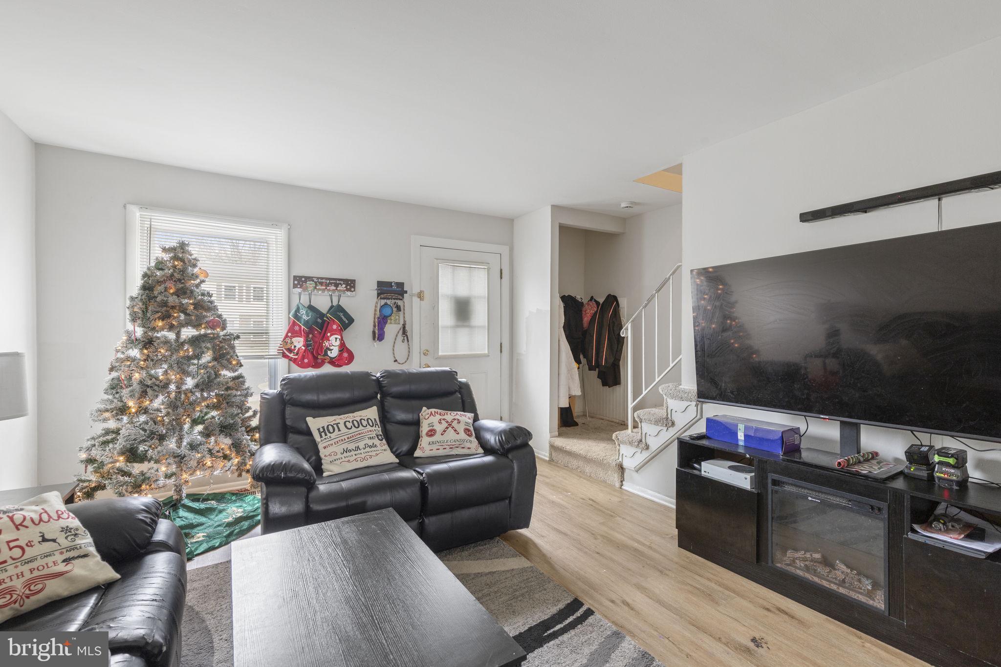 9 Slavin Court, Unit 2H Nottingham, MD 21236 - Photo 3 of 22 a living room with furniture and a flat screen tv