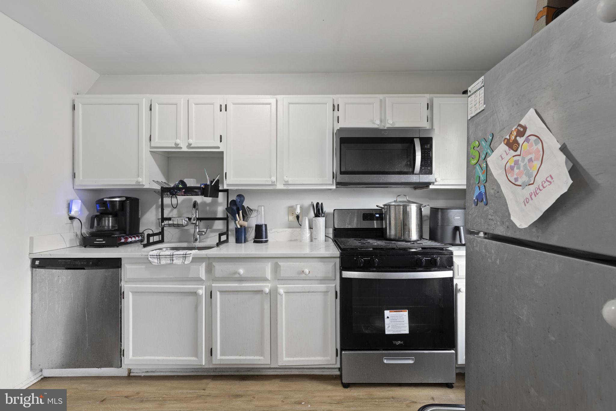 9 Slavin Court, Unit 2H Nottingham, MD 21236 - Photo 5 of 22 a kitchen with stainless steel appliances granite countertop a stove and a microwave