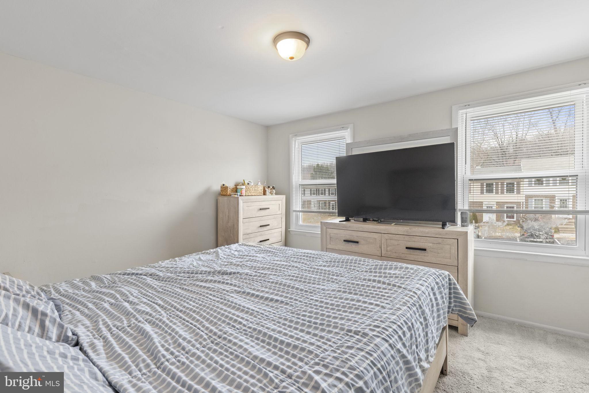 9 Slavin Court, Unit 2H Nottingham, MD 21236 - Photo 7 of 22 a bedroom with a bed and a flat screen tv