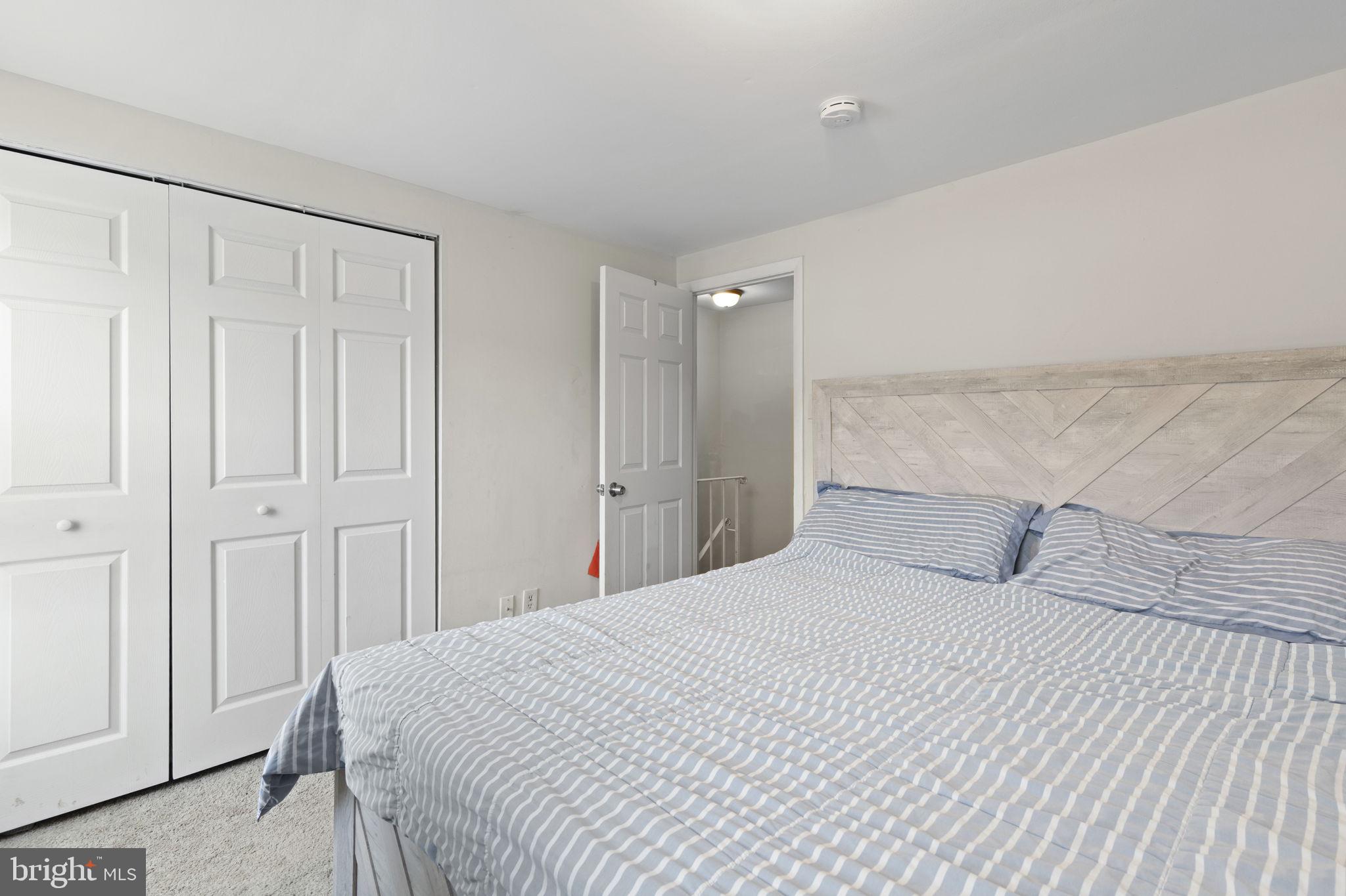 9 Slavin Court, Unit 2H Nottingham, MD 21236 - Photo 8 of 22 a bedroom with a white bed and a shower