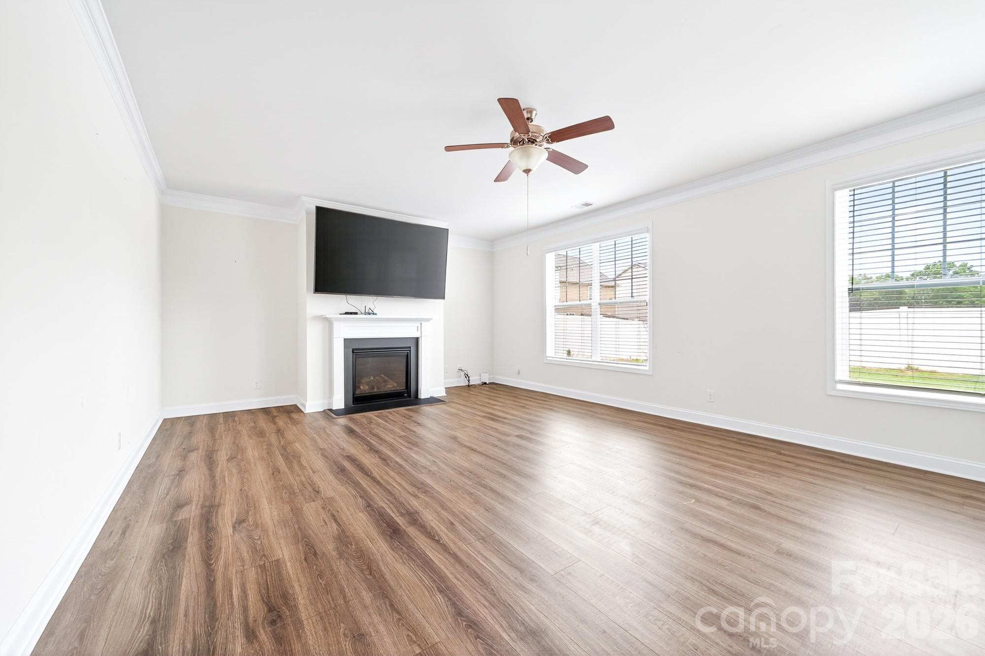 5972 Redwood Pine Road Concord, NC 28027 - Photo 15 of 37 a view of empty room with wooden floor and fireplace