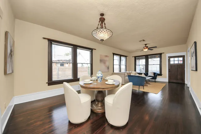 a view of a dining room with furniture wooden floor and chandelier