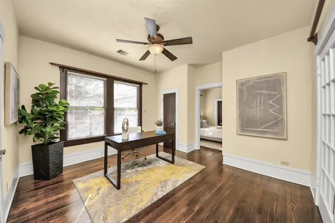 a living room with furniture a window and a potted plant