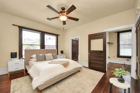 a bedroom with a large bed and a chandelier
