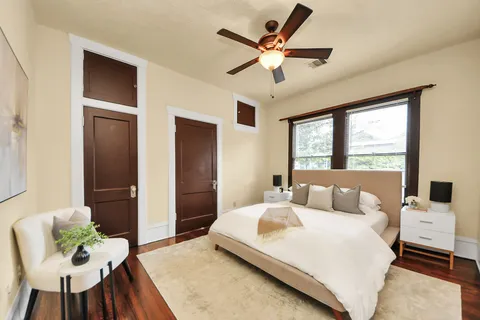 a bedroom with a large bed and a chandelier