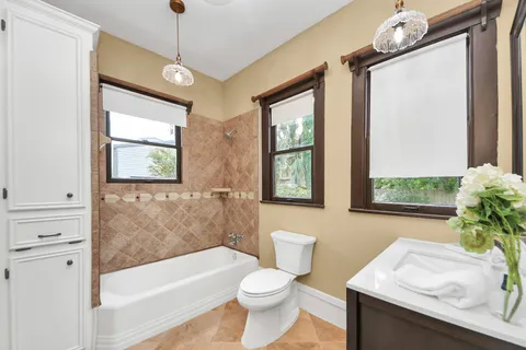 a bathroom with a sink a toilet and bathtub