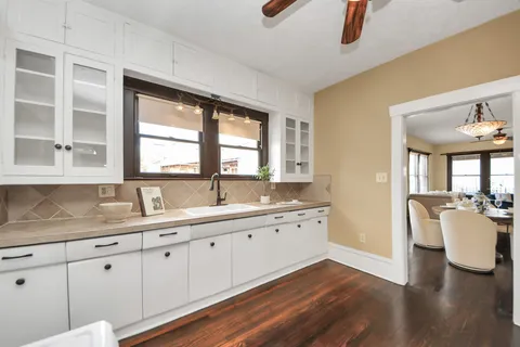 a kitchen with a sink dishwasher and a granite counter top
