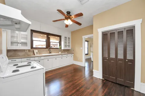 a kitchen with a refrigerator a sink and dishwasher with wooden floor