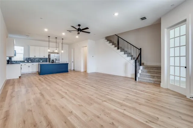 a view of a kitchen with cabinets and wooden floor