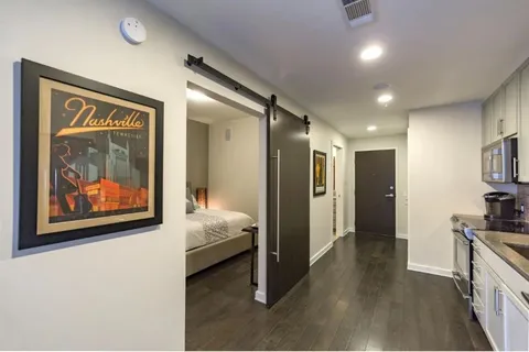 a view of hallway with livingroom and furniture