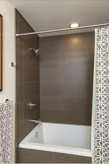 a bathroom with a shower and a bathtub