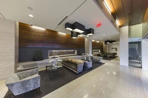 a living room with furniture and kitchen view