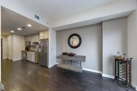 a kitchen with a refrigerator and a stove top oven