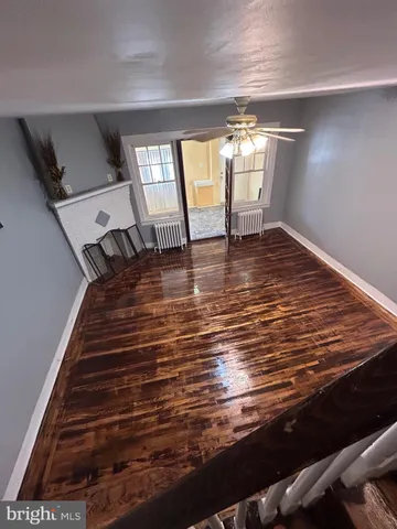 a view of a room with wooden floor