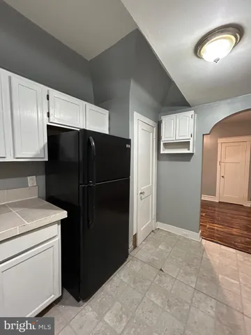 a kitchen with a refrigerator and cabinets