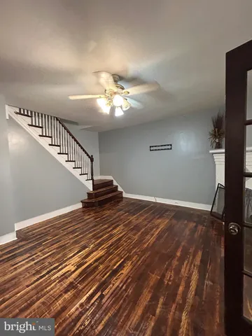 a view of a room with wooden floor and fan