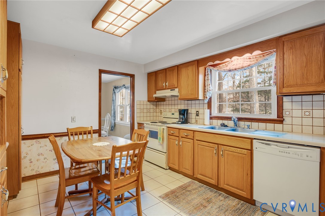 1913 Raintree Drive Henrico, VA 23238 - Photo 18 of 39 a kitchen with a dining table chairs and large window