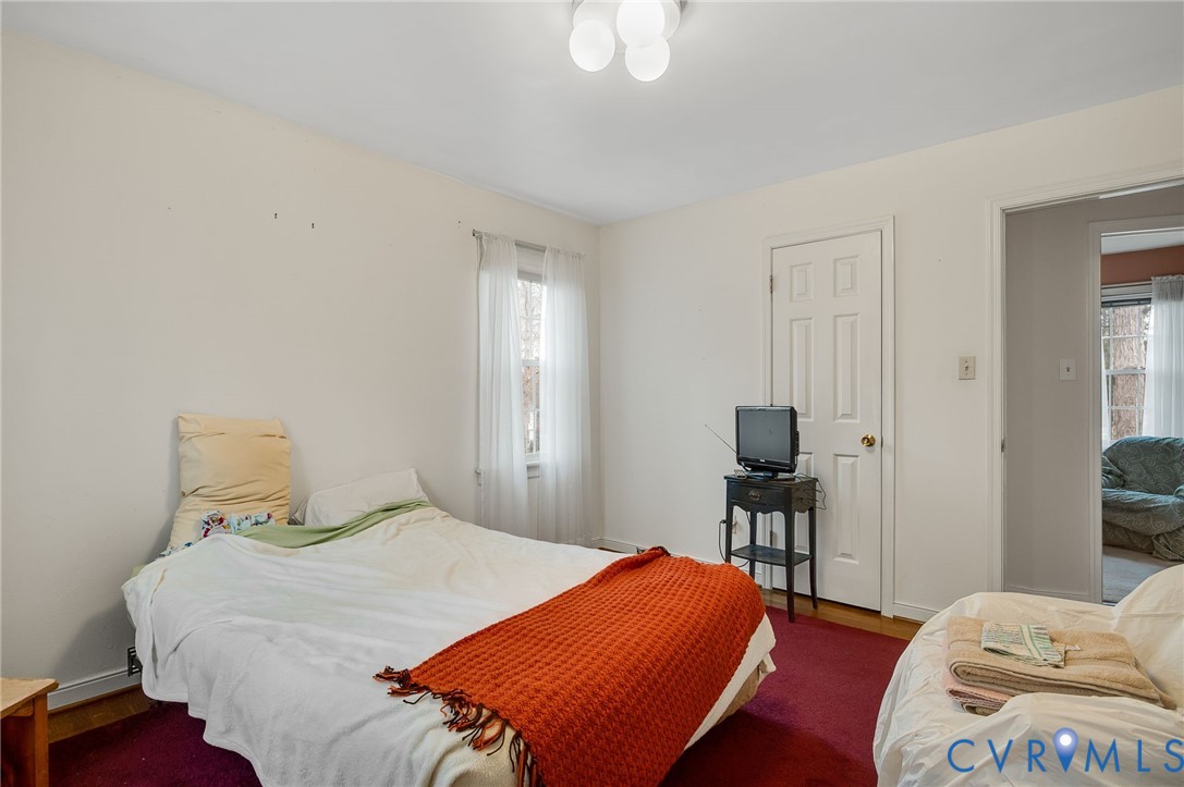 1913 Raintree Drive Henrico, VA 23238 - Photo 34 of 39 a bedroom with a bed and wooden floor