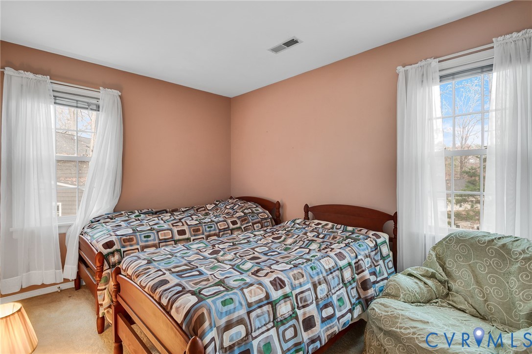 1913 Raintree Drive Henrico, VA 23238 - Photo 35 of 39 a bedroom with a bed and glass window