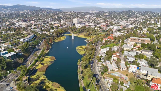 an aerial view of a residential houses with city view