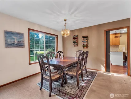 a dining room with furniture window and outside view