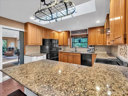 a kitchen with a sink a stove and cabinets